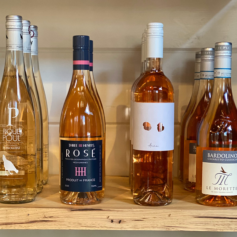 a selection of rosé wine bottles on a shelf at 34th Degree Wine Merchant