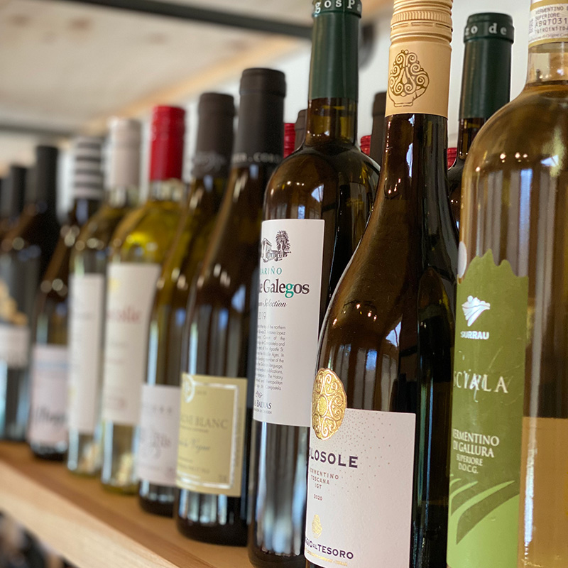 a selection of wine bottles on a shelf at 34th Degree Wine Merchant