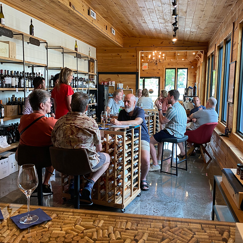 a group of people enjoying a wine tasting at 34th Degree Wine Merchant